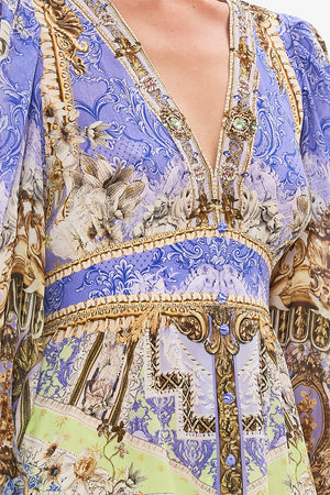 Detail view of model wearing CAMILLA silk frill drfess in Guilded Pleasures print 