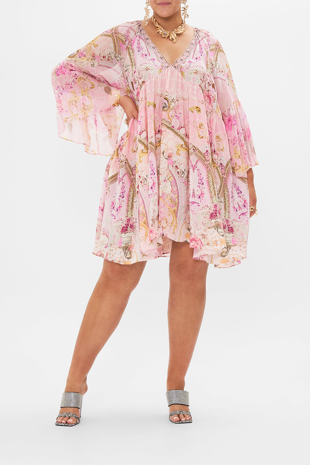 Front view of curvy model wearing CAMILLA  plus size pink silk dress in Fresco Fairytale print 