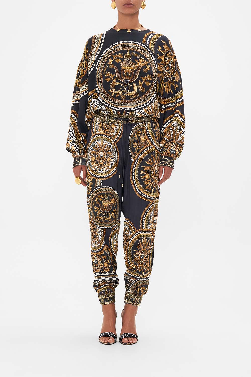 Front view of model wearing CAMILLA printed  track pants in Duomo Kaleido print