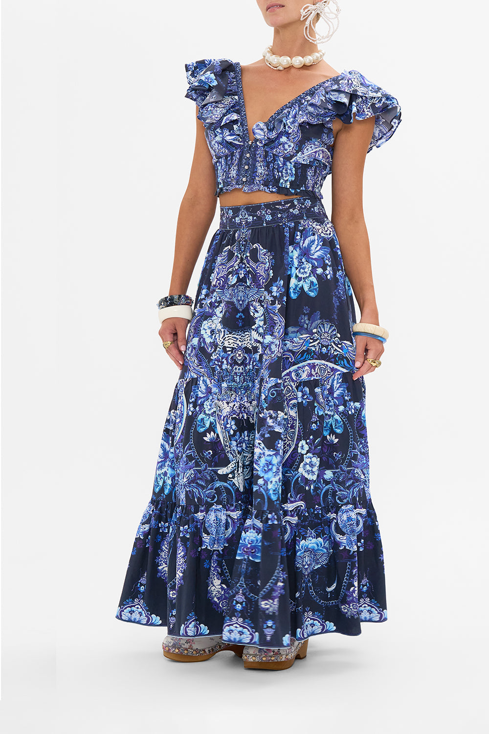 Side view of model wearing CAMILLA maxi skirt in Delft Dynasty print