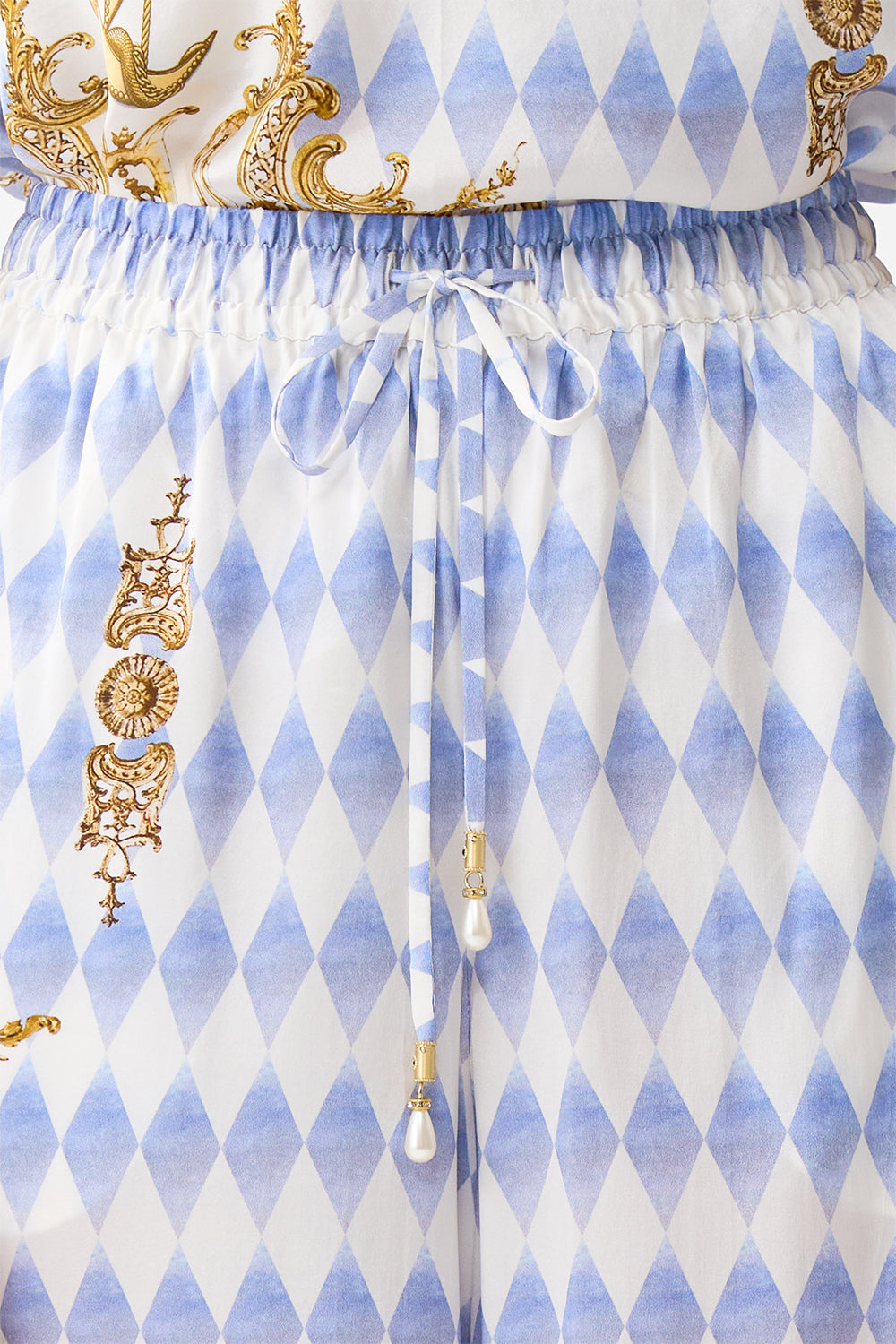 The CAMILLA STEPPED HEM SHIRT SONG OF SAINT ANTHONY in our  print.
