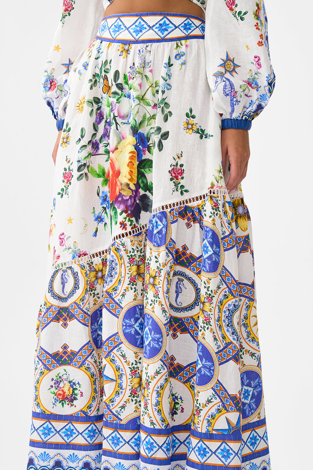 The CAMILLA EYELET WRAP MINI SKIRT WITH TIE WAIST SPIRIT OF SANTA MARIA in our  print.