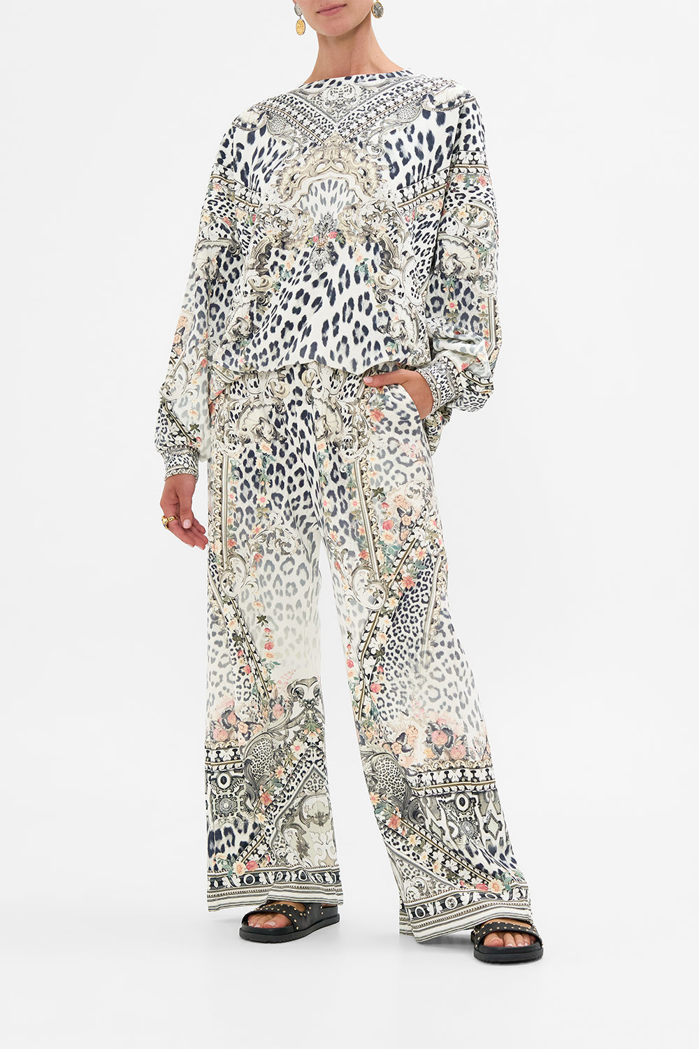 The CAMILLA MID LENGTH BOARDSHORT WITH ELASTIC WAIST NOTES FROM THE ROAD in our  print.