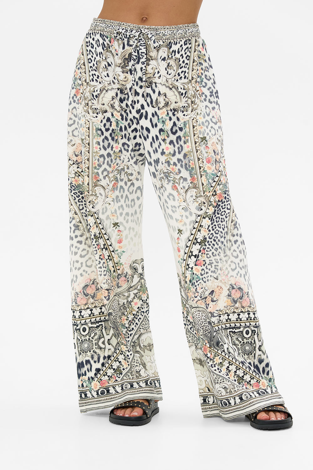 The CAMILLA MID LENGTH BOARDSHORT WITH ELASTIC WAIST NOTES FROM THE ROAD in our  print.