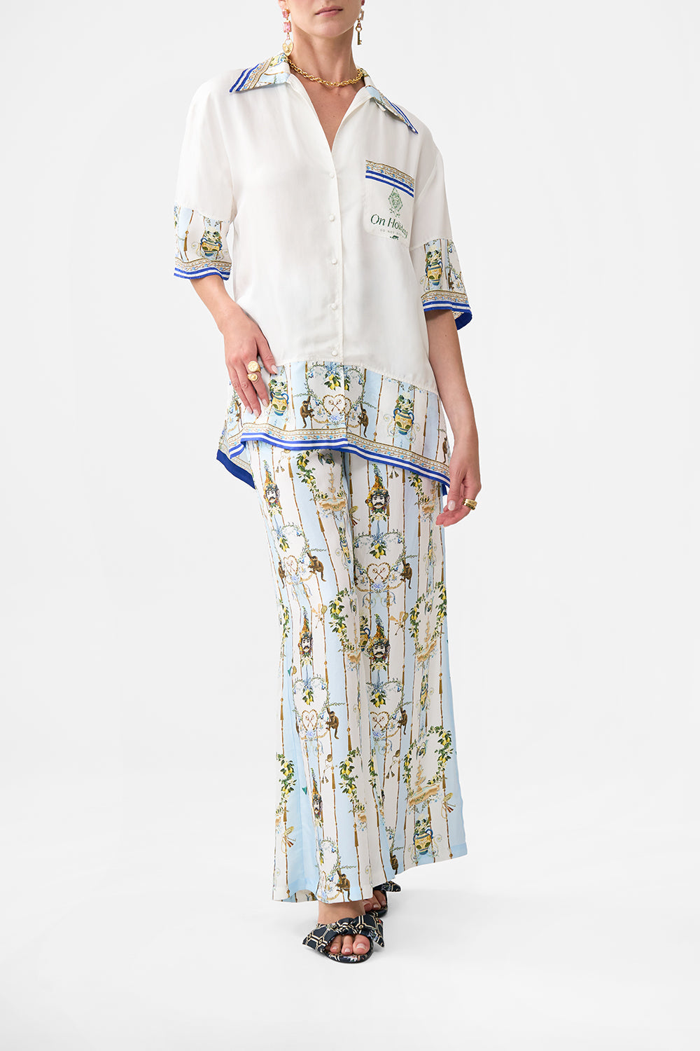 The CAMILLA CROPPED WRAP TOP WITH PLEATED DETAIL NOBLE ENDEAVOURS in our NOBLE ENDEAVOURS print.