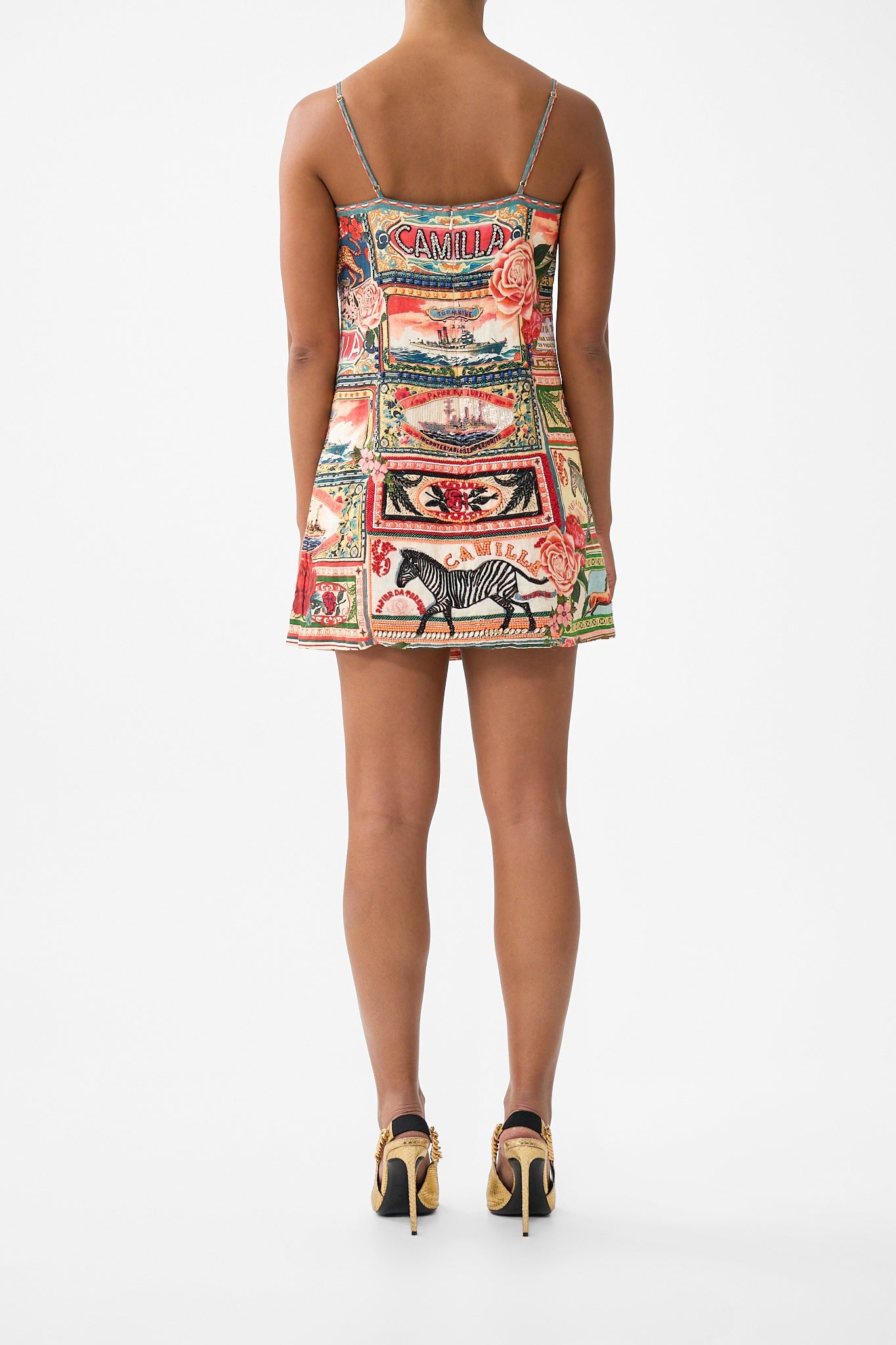 The CAMILLA BABIES GATHERED NECK ROMPER WITH BOW STRAPS MINIATURE MOMENTS in our  print.