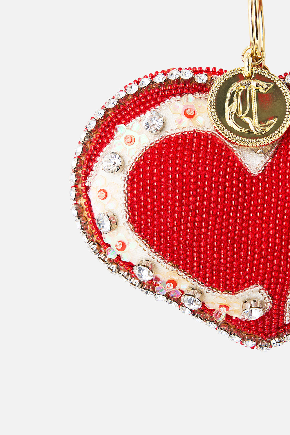The CAMILLA RAFFIA CLUTCH WITH CHARMS NATURAL in our  print.