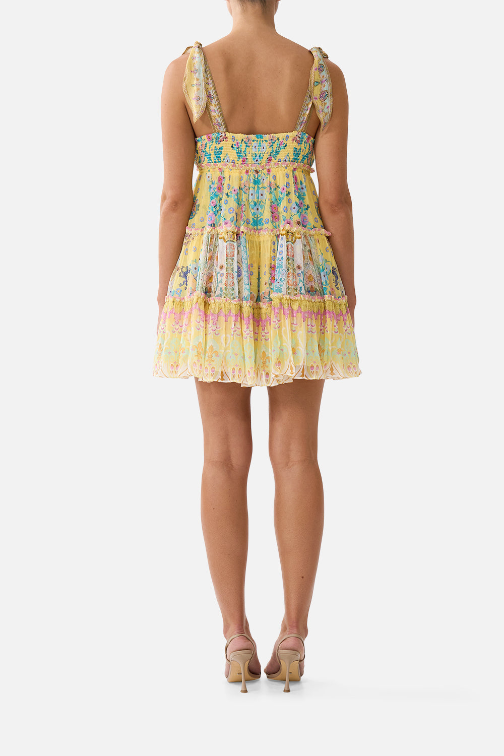 The CAMILLA tiered short dress with shoulder ties in our print Barcelona Bebé. Back model view.