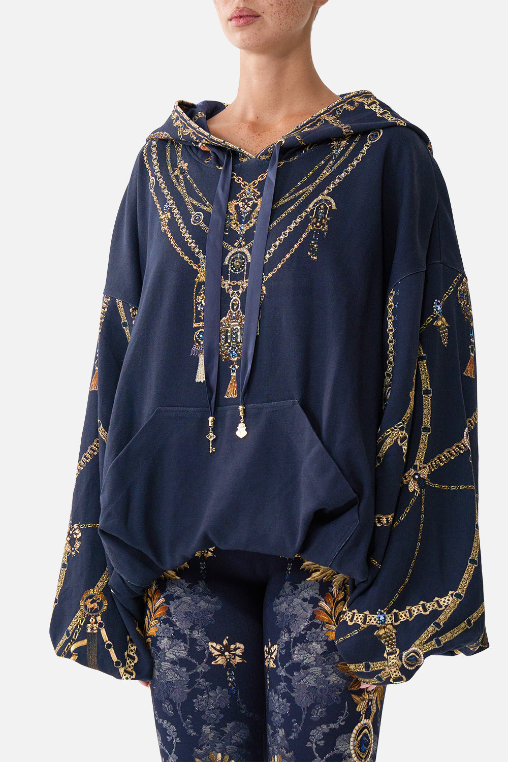 The CAMILLA Oversized Slouch Hoodie in our Cloaked in Baroque print, detail view on model.