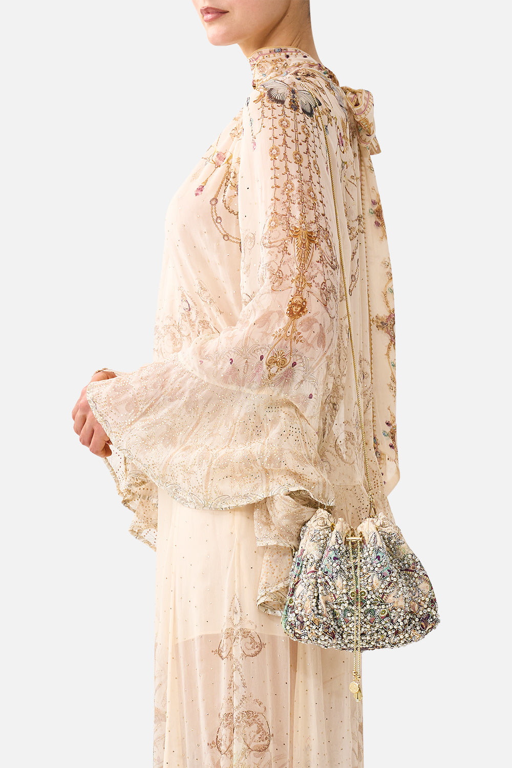 The CAMILLA Drawstring Pouch Bag with Chain Strap in our A Meeting of Masterpieces print, side view on model.