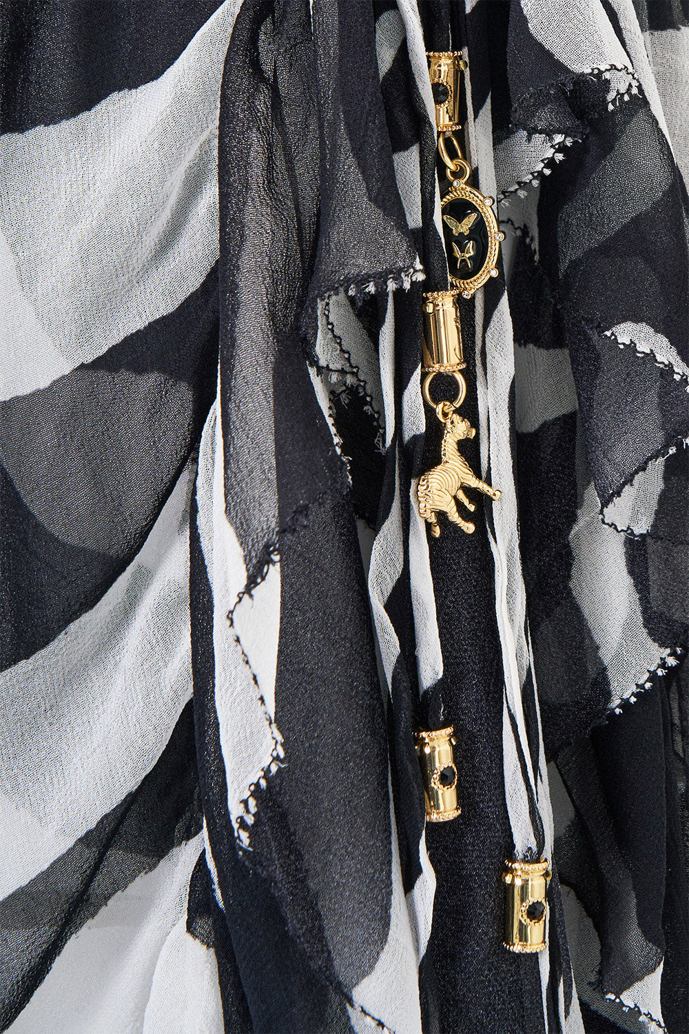 The CAMILLA Relaxed Wrap Tie Skirt with Ruffle in our Zig Zag Zoo print, fabric detail.