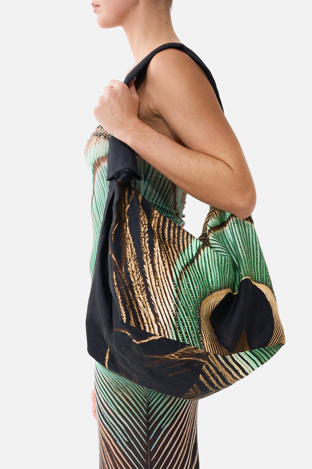 The CAMILLA Slouch Shoulder Bag With Knot Details in Print A Wink to the Wild. Model View