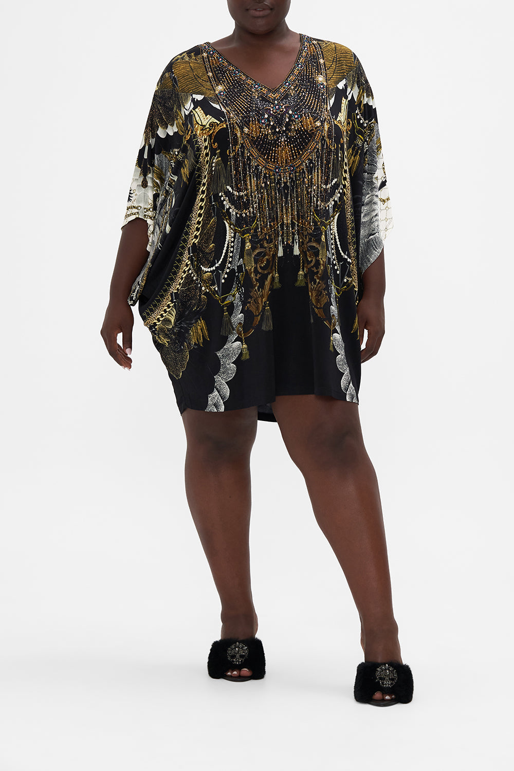 Front view of curvy model wearing CAMILLA Plus size  jersey tunic dress in Ravin Raven print 